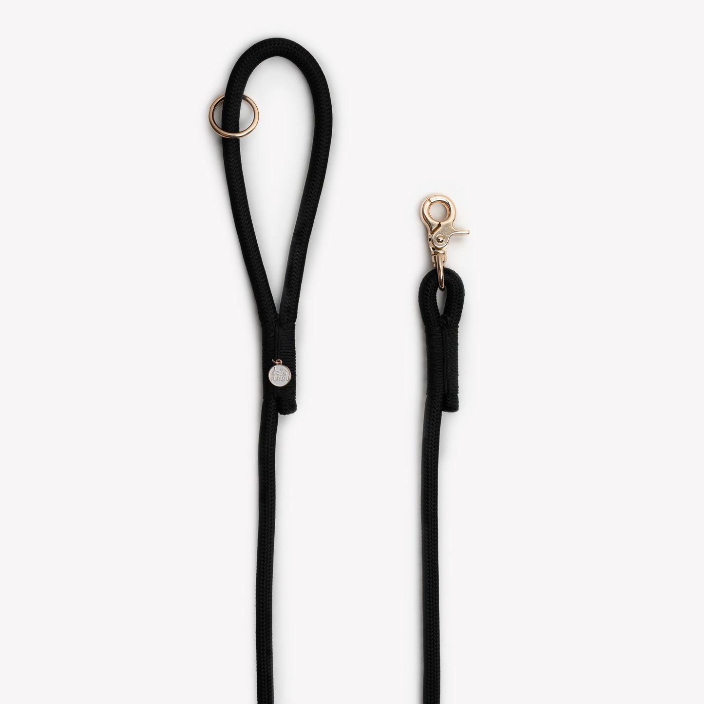 Black dog leash with gold clasp on a white background