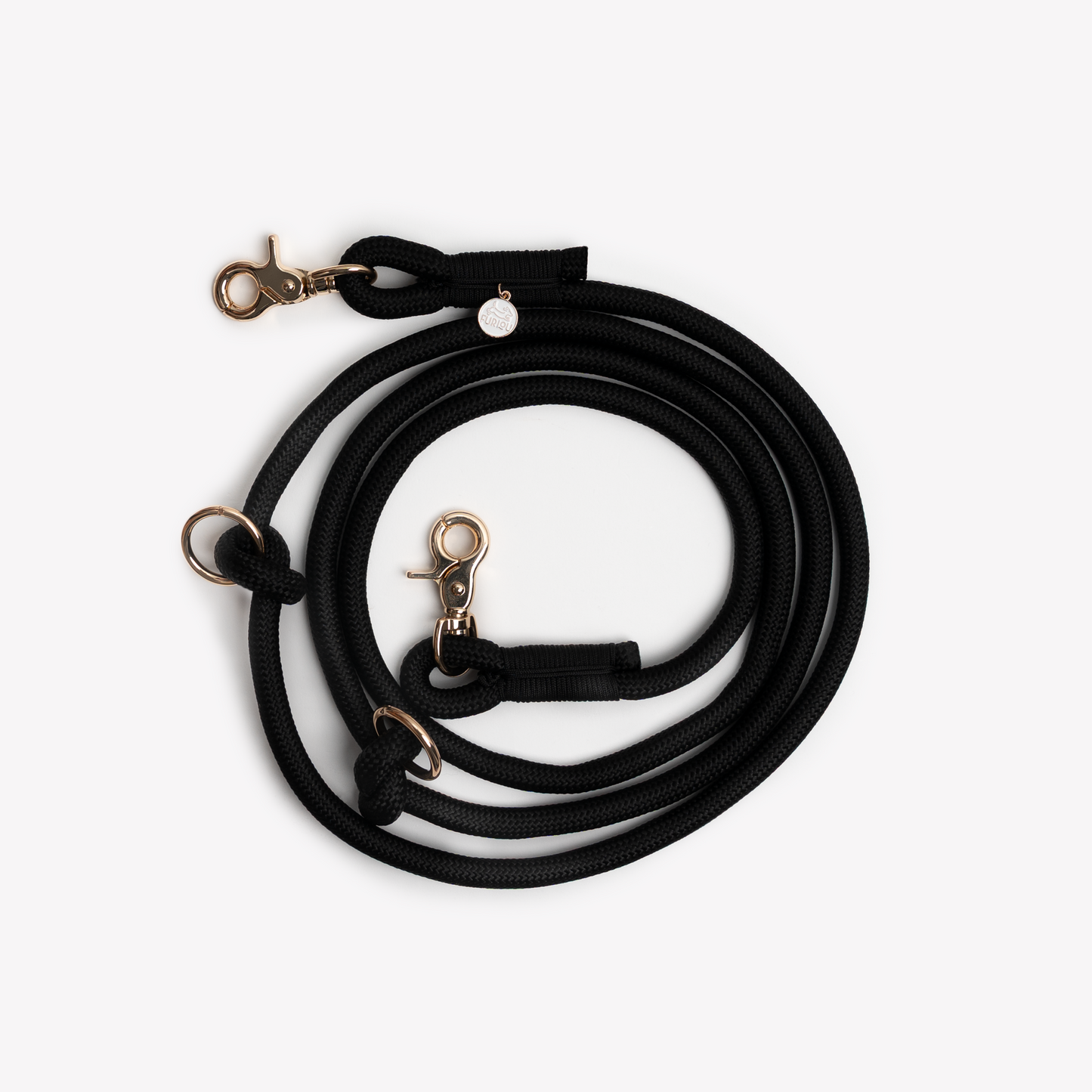 Black hands-free dog leash with gold clasp on a white background