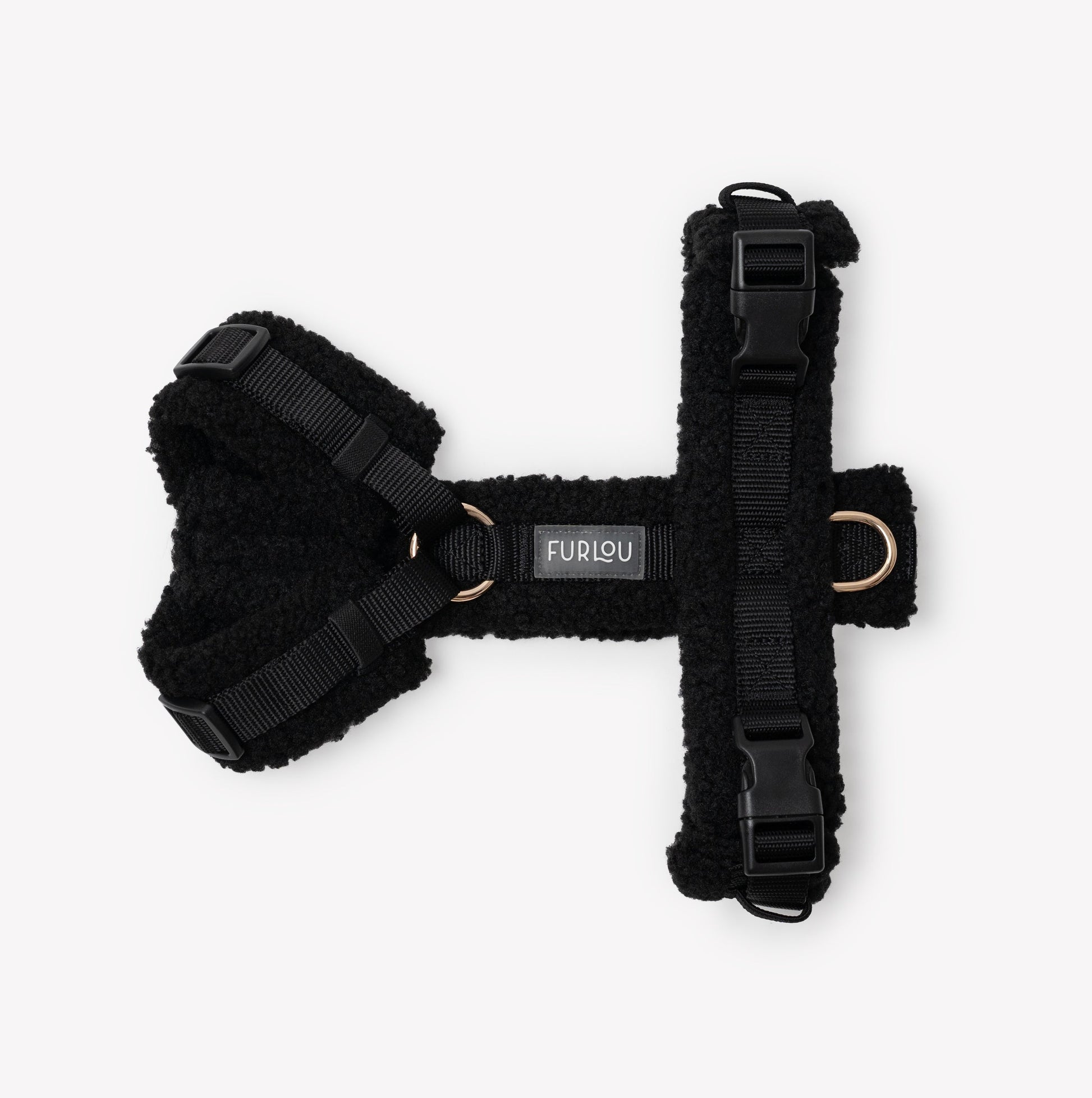 Black dog harness with Furlou label on a white background