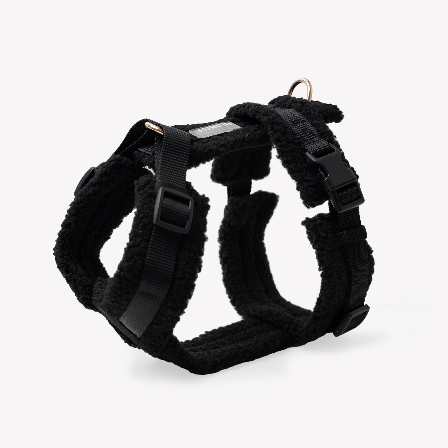 Black dog harness on a light gray background