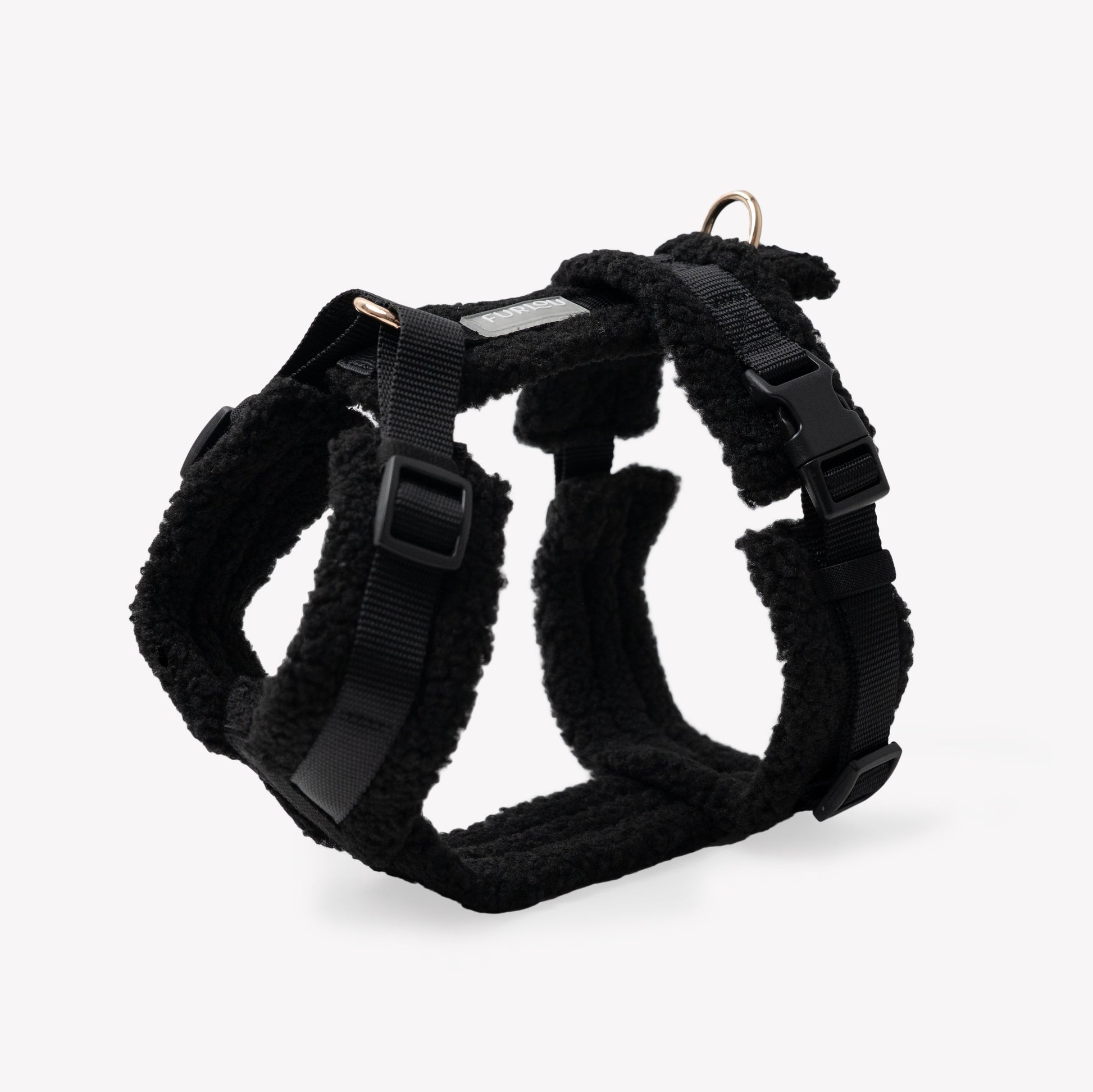 Black dog harness on a light gray background