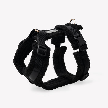 Black dog harness on a light gray background