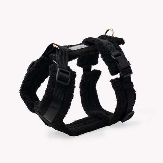 Black dog harness on a light gray background