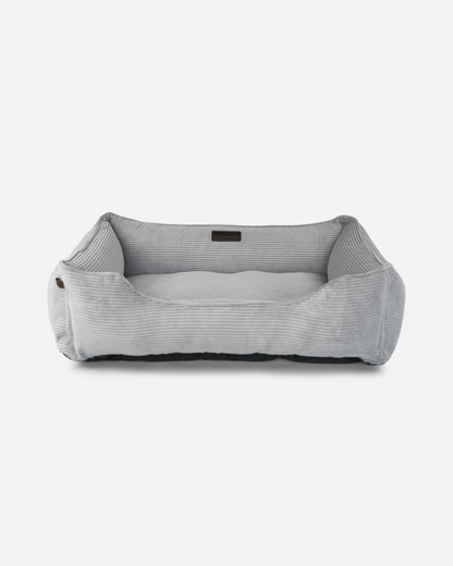 Gray pet bed with a ribbed texture on a white background