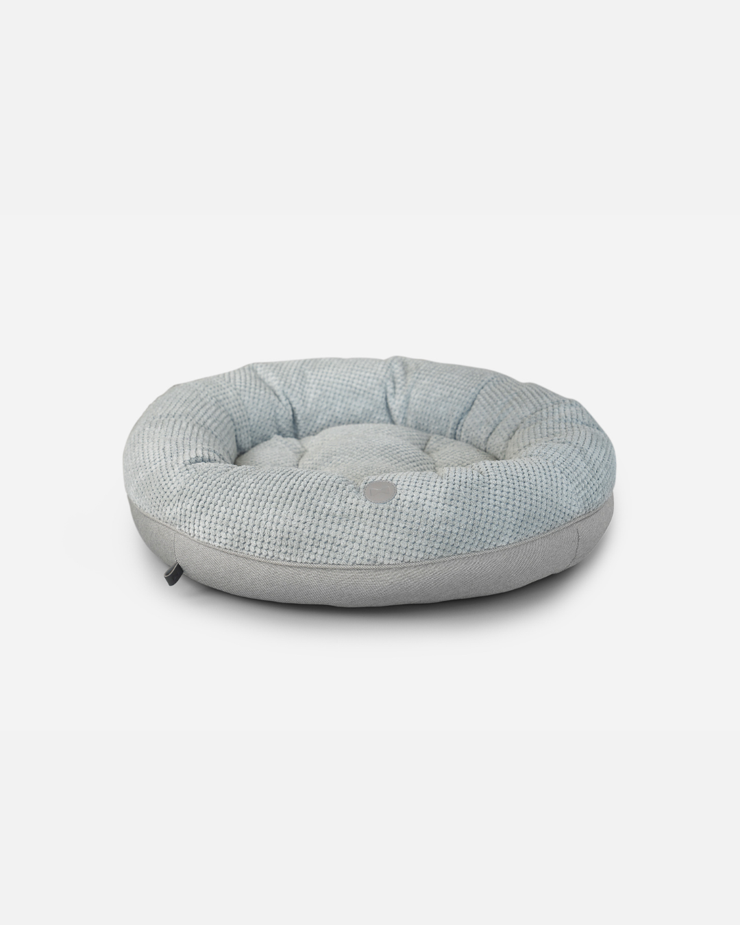 Round pet bed with a textured pattern on a white background