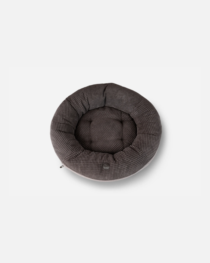 Round gray pet bed on a white background
