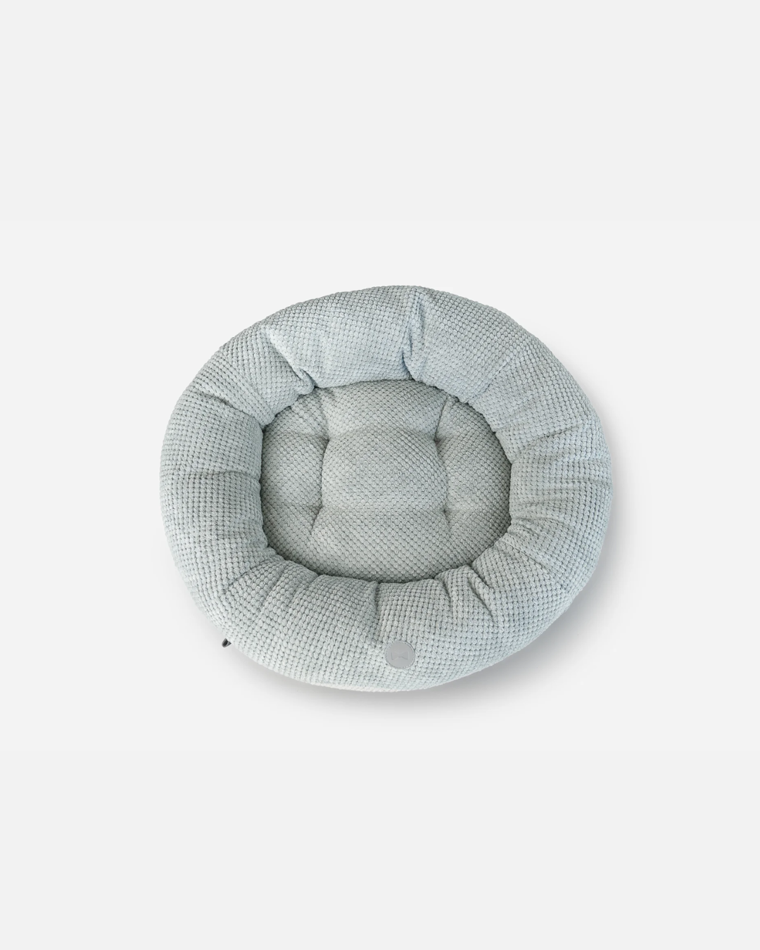 Round pet bed with a checkered pattern on a white background