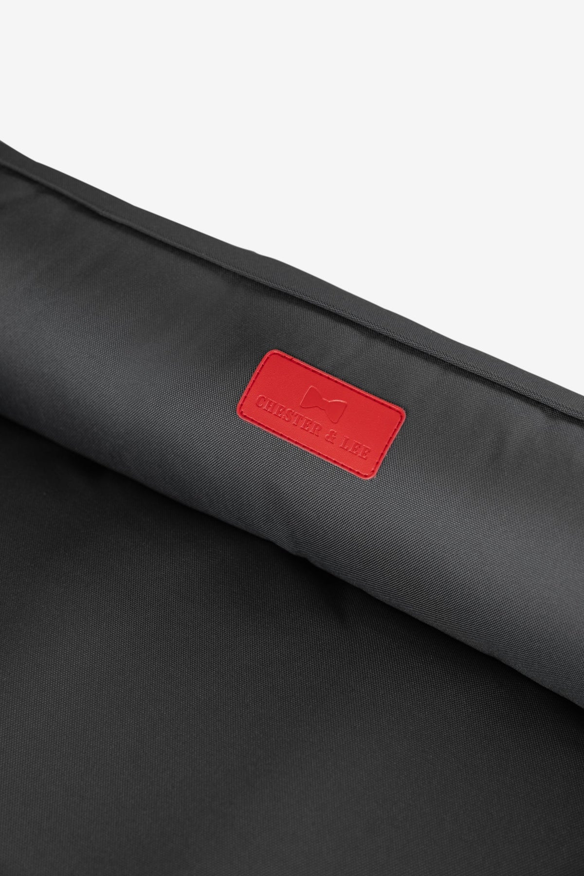 Close-up of durable waterproof fabric and red brand patch