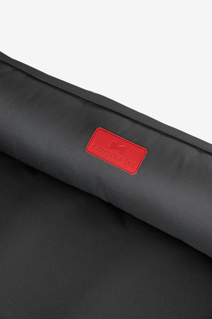 Close-up of durable waterproof fabric and red brand patch