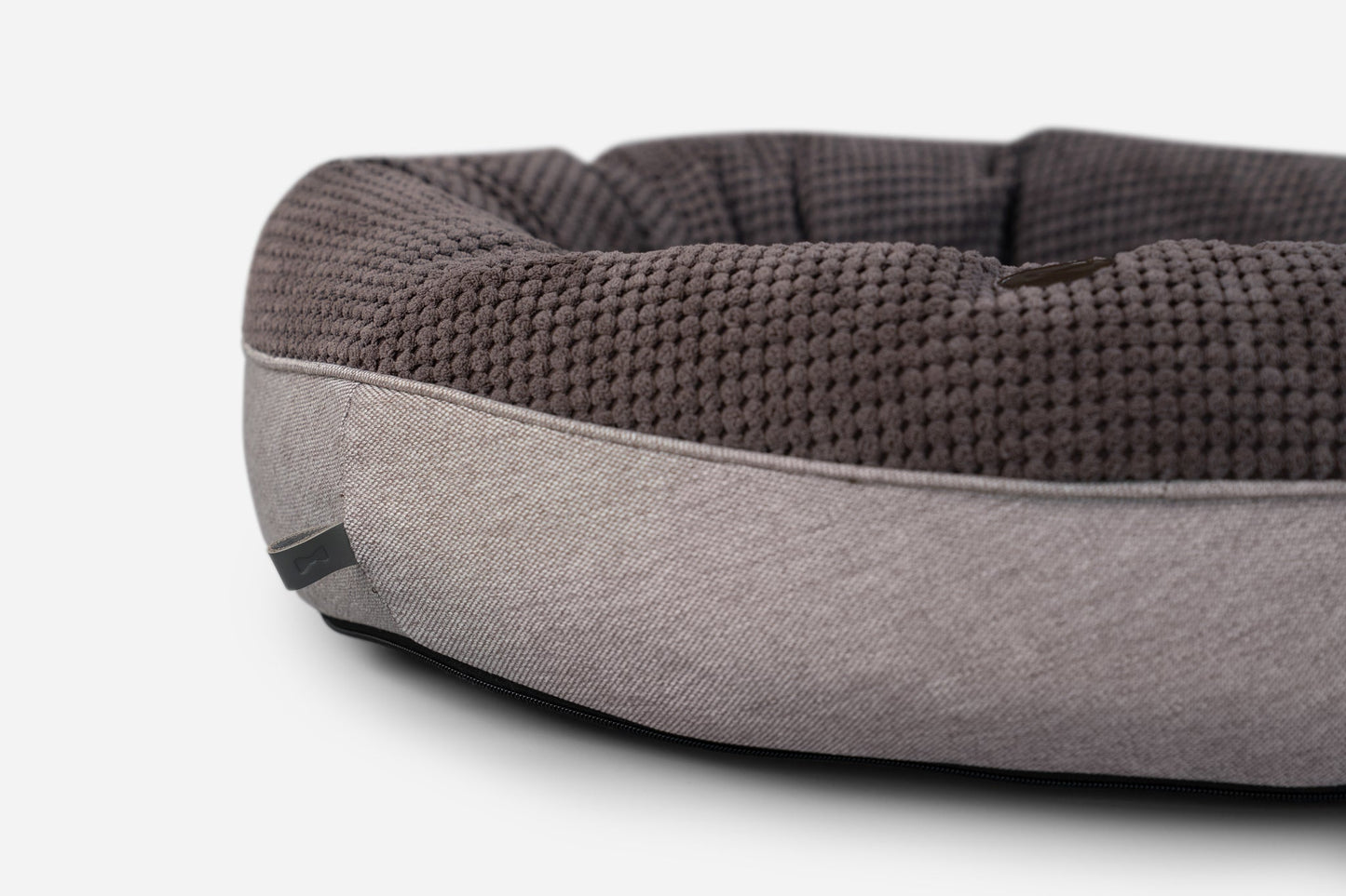 Gray and brown pet bed on a white background