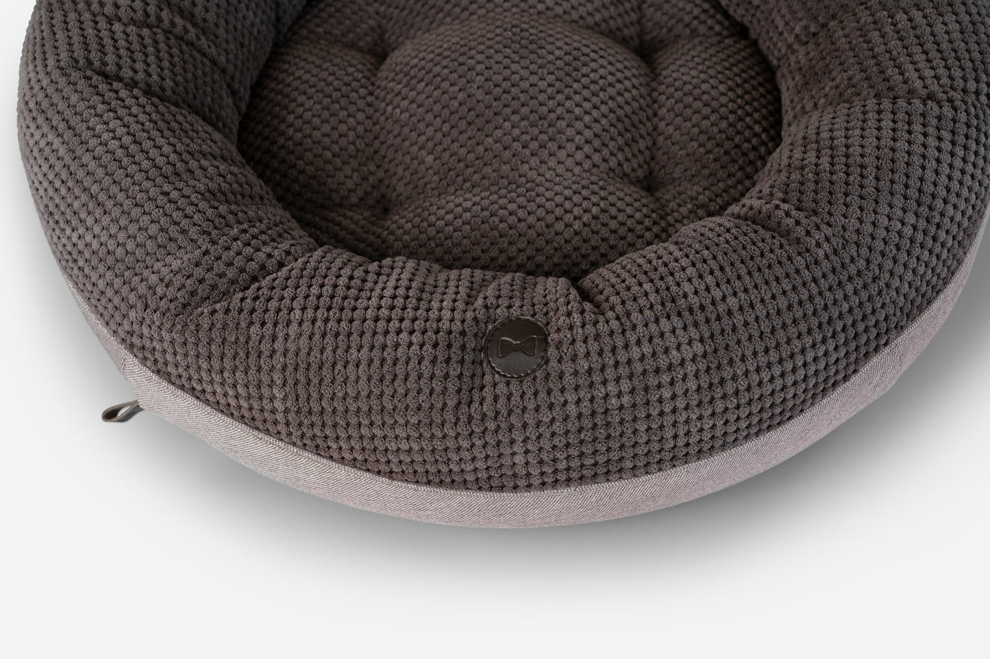 Round knitted pet bed on a white background