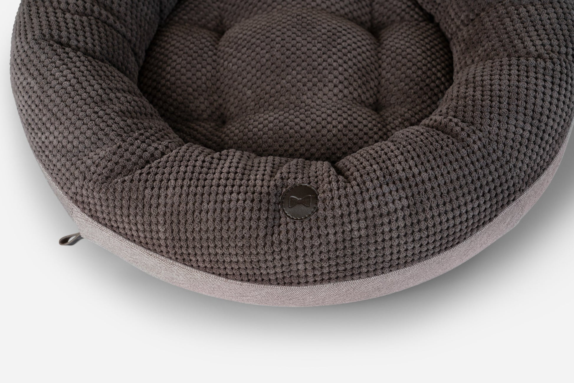 Round knitted pet bed on a white background