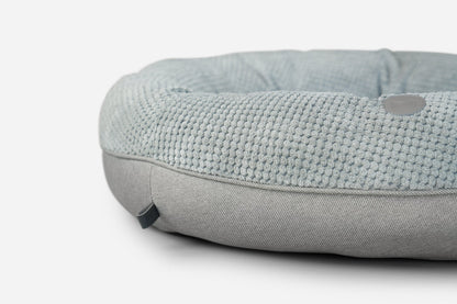 Gray textured pet bed on a white background