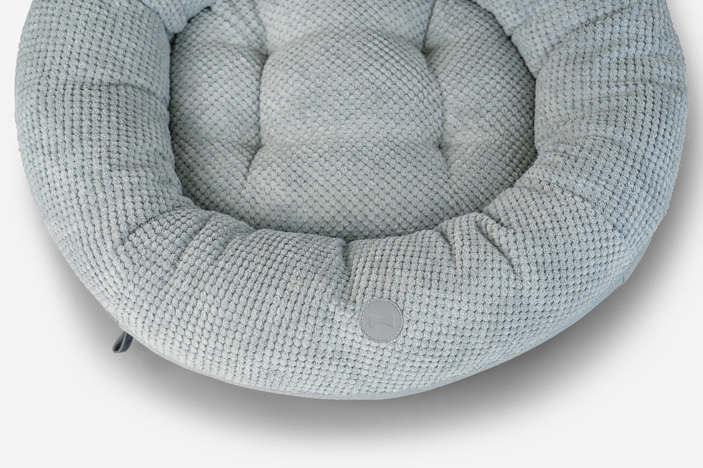 Textured gray pet bed on a white background