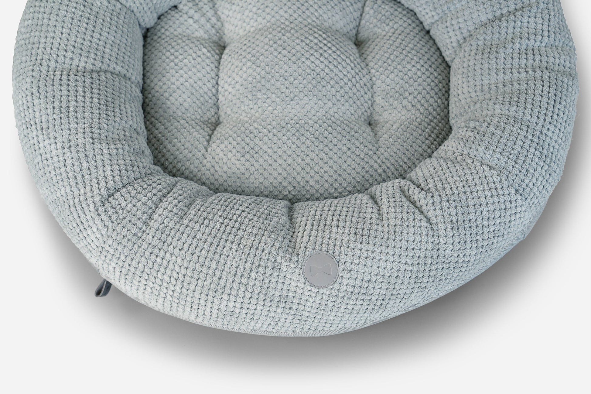 Textured gray pet bed on a white background