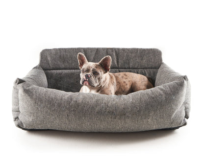Small dog in the performance tweed car bed on white