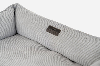 Gray ribbed fabric with a brand logo on a white background