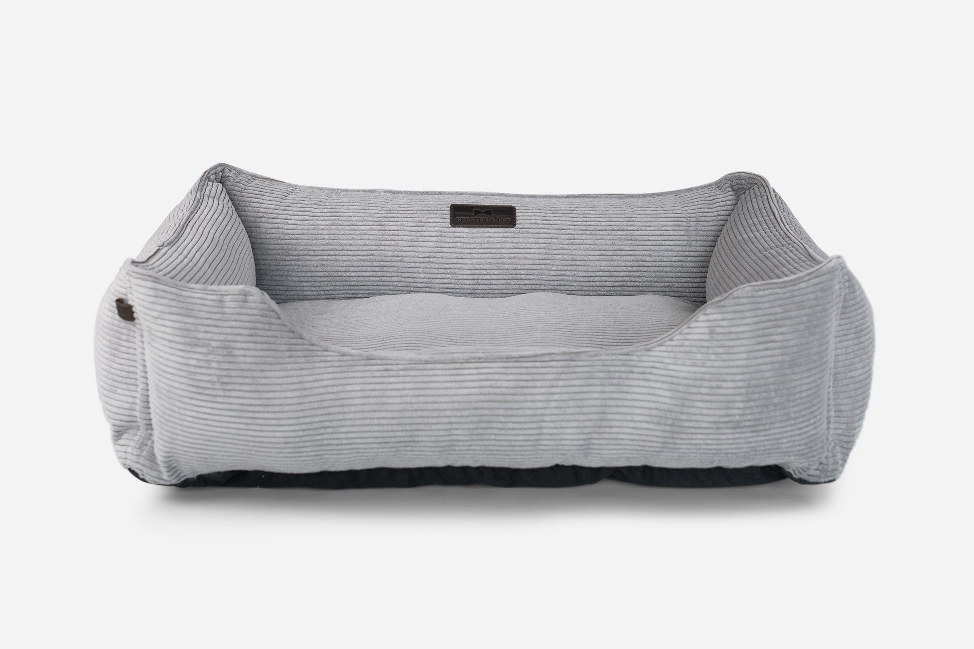 Gray pet bed with a black label on a white background