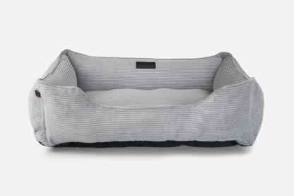 Gray pet bed with a black label on a white background