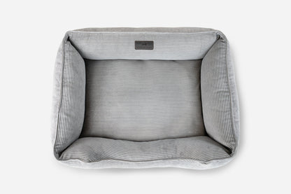 Gray pet bed with striped pattern on a white background