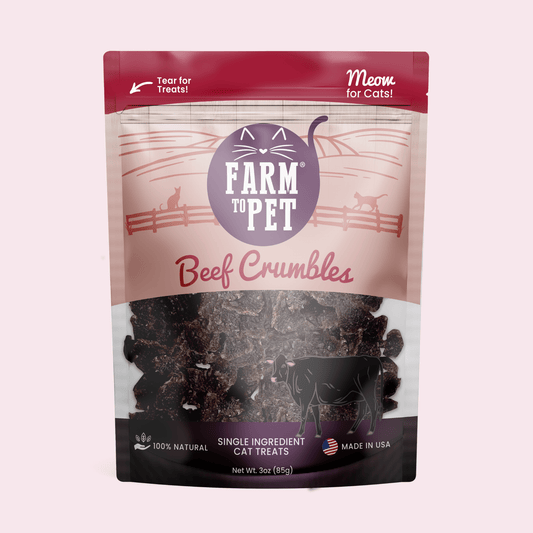 Package of Farm to Pet Beef Crumbles cat treats on a pink background