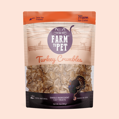 Package of Farm to Pet Turkey Crumbles cat treats on a beige background