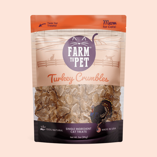Package of Farm to Pet Turkey Crumbles cat treats on a beige background