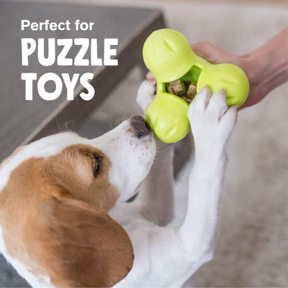 Dog reaching into a green puzzle toy filled with freeze-dried beef heart treats.