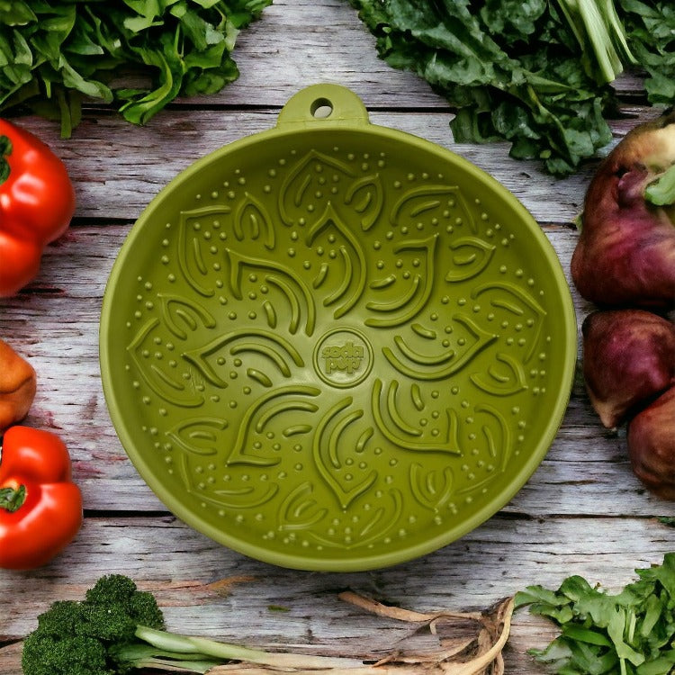 Green Garden of Eatin' Tipsy Bowl displayed on a wooden surface with vegetables.