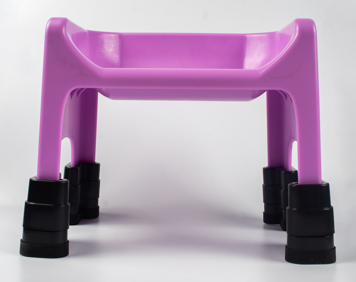 Pink Fluff Trough raised on four black stackable lift supports.