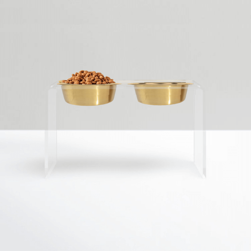Tall clear double feeder with gold bowls on white