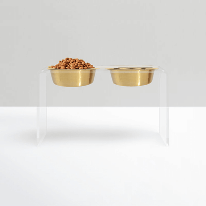 Tall clear double feeder with gold bowls on white