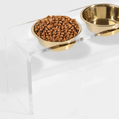 Close-up of gold bowls in the clear double feeder