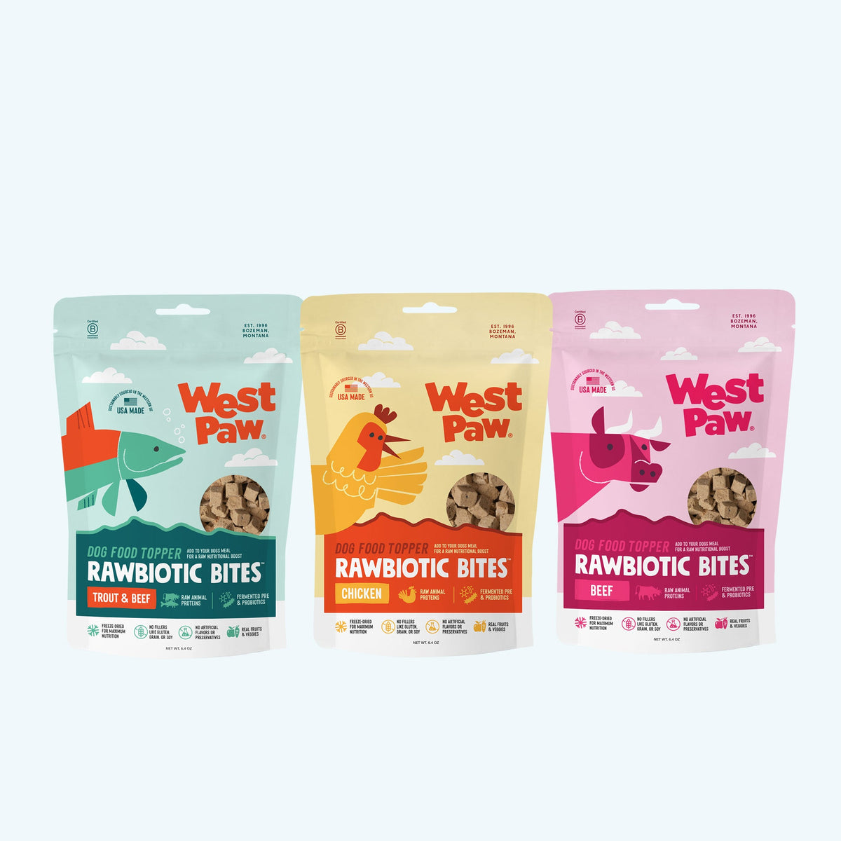 Three West Paw Rawbiotic Bites topper recipes in trout, chicken, and beef packages.