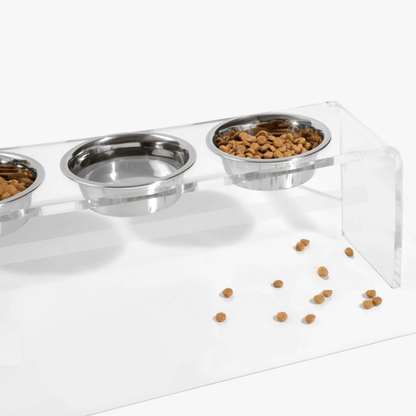 Close-up of food and water in the triple silver feeder