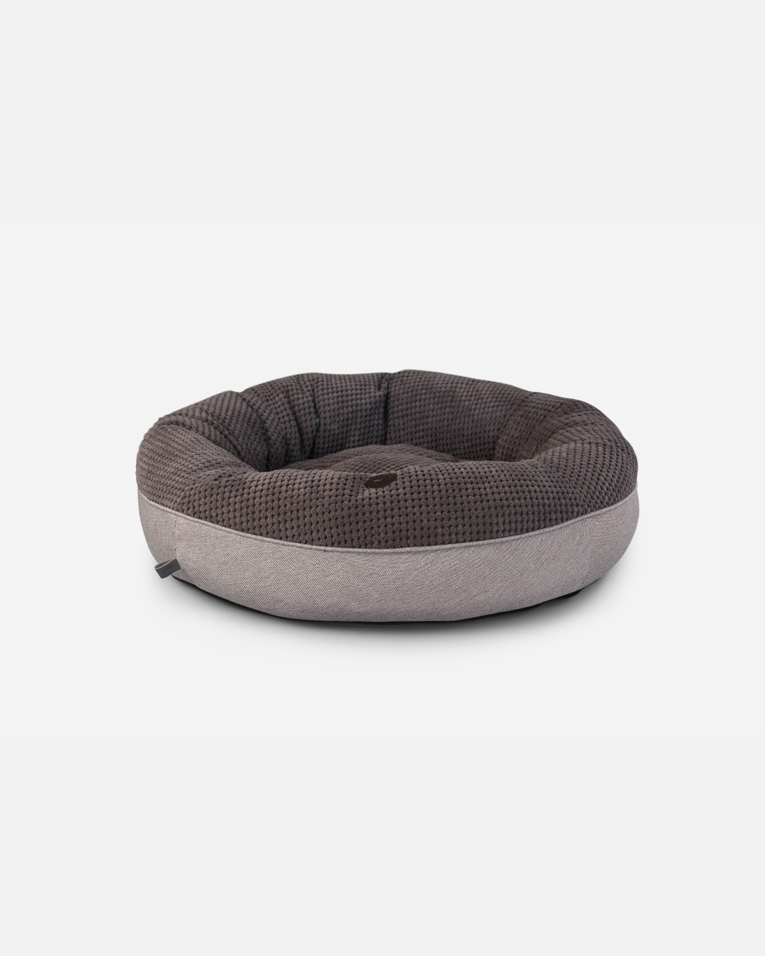 Two-toned pet bed with brown top and gray bottom on a white background