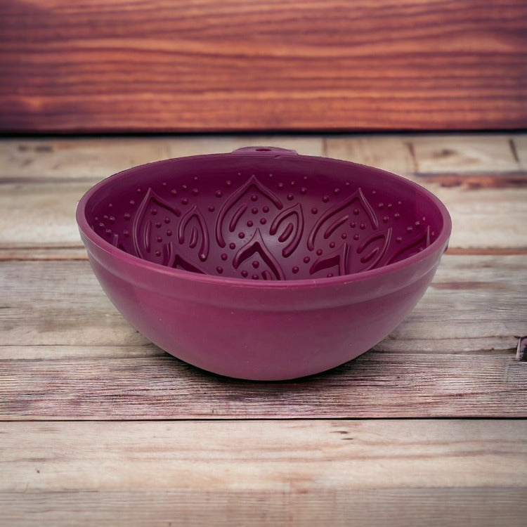 Empty plum Garden of Eatin' Tipsy Bowl angled on a wooden surface.