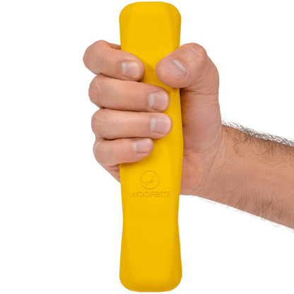 Monster K9 Power Stick bright yellow rubber dog toy on a white background