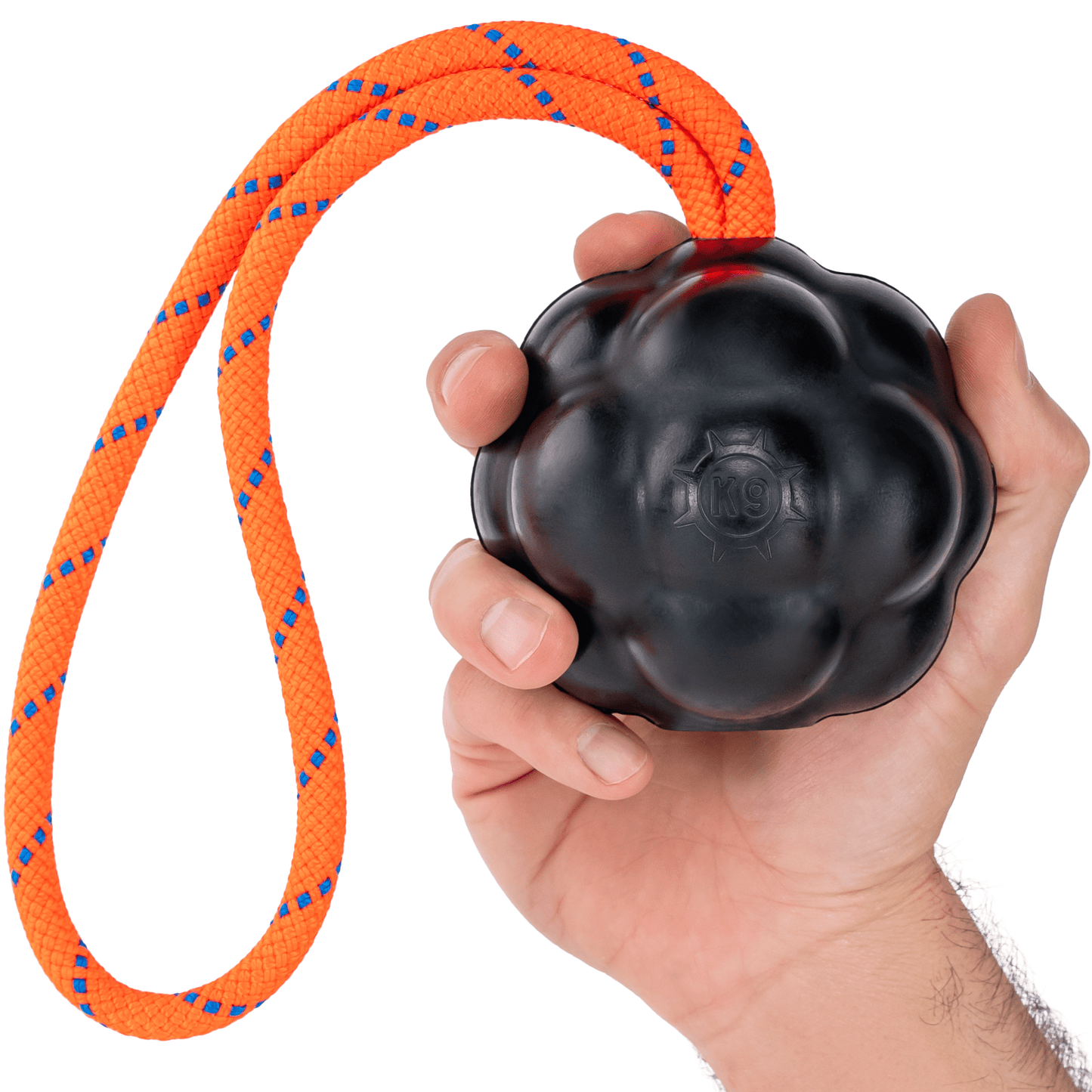 Black dog toy with orange rope held in a hand on a white background