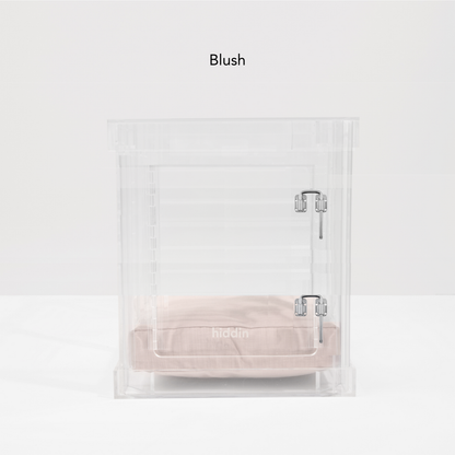 Small clear pet crate with blush cushion and silver latch